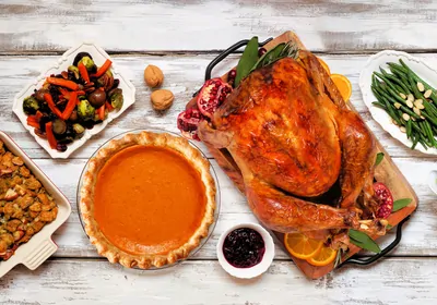 Turkey, mashed potatoes, stuffing, pumpkin pie and sides on a table Turkey, mashed potatoes, stuffing, pumpkin pie and sides on a table